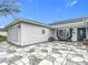 A home featuring a stone-patterned drive way, a two car garage, and covered porch at 2488 Cherokee Ct, The Villages, FL 32162