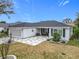 View of the front of the property with stone-patterned drive way and a two car garage at 2488 Cherokee Ct, The Villages, FL 32162