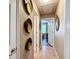 Hallway featuring decorative mirrors and neutral colored tile flooring at 2488 Cherokee Ct, The Villages, FL 32162