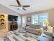 Cozy living room with a large window and ceiling fan, with direct access to the front door at 2488 Cherokee Ct, The Villages, FL 32162