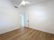 This cozy bedroom features a ceiling fan and wood-look floors at 2520 Chanute Trl, Maitland, FL 32751