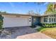 Single-story home with white garage door, stone walkway, and updated entryway at 2520 Chanute Trl, Maitland, FL 32751