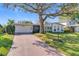 Charming single-story home with brick driveway, lush lawn, and mature shade tree at 2520 Chanute Trl, Maitland, FL 32751