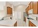 Bright kitchen featuring tile floors, white countertops, and plenty of cabinet space for efficient storage at 2556 Brookstone Dr, Kissimmee, FL 34744