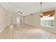 Bright and airy living room featuring tiled flooring, neutral walls, and double doors leading to the patio at 2556 Brookstone Dr, Kissimmee, FL 34744