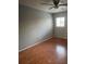 Cozy bedroom with wood floors, ceiling fan, and window for natural light at 285 Scottsdale Sq # 285, Winter Park, FL 32792