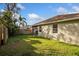 A grassy backyard with a privacy fence and mature landscaping, adjacent to the property's exterior wall at 329 Streamview Way, Winter Springs, FL 32708