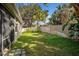 A grassy backyard with a wooden privacy fence and mature landscaping creating a serene outdoor space at 329 Streamview Way, Winter Springs, FL 32708