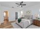 Bright bedroom features wood floors, a ceiling fan, and tasteful decor for a relaxing retreat at 329 Streamview Way, Winter Springs, FL 32708