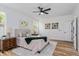 Comfortable bedroom featuring wood floors, a ceiling fan, and tasteful decor for a relaxing retreat at 329 Streamview Way, Winter Springs, FL 32708