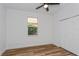 A clean bedroom features wood floors, a ceiling fan, a window, and built in closets at 329 Streamview Way, Winter Springs, FL 32708