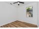 A clean bedroom features wood floors, a ceiling fan, and a window at 329 Streamview Way, Winter Springs, FL 32708