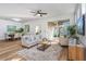 Bright living room with wood floors, stylish furniture, and sliding door to the patio at 329 Streamview Way, Winter Springs, FL 32708