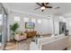 Cozy living area with a large window, comfortable seating, and a ceiling fan at 329 Streamview Way, Winter Springs, FL 32708