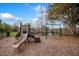 Community playground with slide, swings, and climbing area; scenic lake view with fencing at 329 Streamview Way, Winter Springs, FL 32708