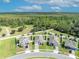 An aerial view of a neighborhood with well manicured lawns and preserved land in the background at 3563 Fernanda Dr, Deltona, FL 32738