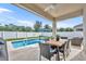 Relaxing covered patio with pool, perfect for enjoying outdoor dining and lounging by the water at 3563 Fernanda Dr, Deltona, FL 32738