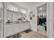 Bathroom featuring a double vanity, granite countertops and a view of the walk-in closet at 3563 Fernanda Dr, Deltona, FL 32738