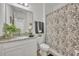 Modern bathroom featuring a granite countertop, white cabinets, and tiled shower at 3563 Fernanda Dr, Deltona, FL 32738