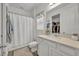 Bright bathroom featuring white fixtures, a shower-tub combo, and storage at 3563 Fernanda Dr, Deltona, FL 32738