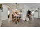 Cozy dining area with a wood accent wall, pendant lighting, and wood-look floors at 3563 Fernanda Dr, Deltona, FL 32738