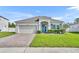 Charming single-story home featuring a well-manicured lawn and a brick driveway at 3563 Fernanda Dr, Deltona, FL 32738