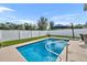 Backyard pool area with an umbrella and a privacy fence at 3563 Fernanda Dr, Deltona, FL 32738