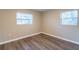 Bedroom featuring new flooring, baseboards, and two windows for natural light at 4108 Westgate Rd, Orlando, FL 32808