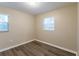 This is a cozy bedroom with two windows and hard surface floors at 4108 Westgate Rd, Orlando, FL 32808