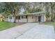 Exterior side view of single story home with driveway and covered parking area at 4108 Westgate Rd, Orlando, FL 32808