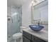 Modern bathroom featuring a marble shower, a sleek vanity and vessel sink at 441 Spoonbill Ct, Kenansville, FL 34739