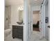 A modern bathroom with a vessel sink, marble floors, and a view through to a seating area at 441 Spoonbill Ct, Kenansville, FL 34739