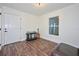 Simple bedroom space featuring hardwood floors, natural light, and minimal furnishings at 441 Spoonbill Ct, Kenansville, FL 34739