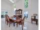 Well-lit dining room with tall windows and a classic wooden table at 441 Spoonbill Ct, Kenansville, FL 34739