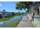 Waterfront property featuring a private wooden dock, ideal for boating and enjoying scenic water views at 441 Spoonbill Ct, Kenansville, FL 34739