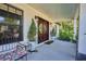 Inviting front porch featuring a double front door with glass windows, potted plants, and stylish decor at 441 Spoonbill Ct, Kenansville, FL 34739