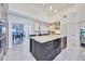 Bright and airy kitchen featuring an island with wine storage and marble countertops, adjacent to a dining area at 441 Spoonbill Ct, Kenansville, FL 34739