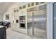 Beautiful white kitchen with stainless steel refrigerator and modern built-in appliances at 441 Spoonbill Ct, Kenansville, FL 34739