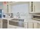 Farmhouse style stainless steel kitchen sink with modern faucet and white countertops at 441 Spoonbill Ct, Kenansville, FL 34739