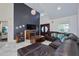 Cozy living room featuring dark accent wall, fireplace, media console, and comfortable sectional seating at 441 Spoonbill Ct, Kenansville, FL 34739