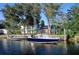 Waterfront property features a private dock and boat lift on a canal leading to open water at 441 Spoonbill Ct, Kenansville, FL 34739