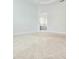 Bright bedroom featuring neutral walls and carpet with a view into the ensuite bathroom at 4612 Terry Town Dr, Kissimmee, FL 34746