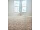 Bedroom featuring two large windows and plush carpeting at 4612 Terry Town Dr, Kissimmee, FL 34746