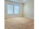 Spacious bedroom with neutral carpet and natural light from two bright windows at 4612 Terry Town Dr, Kissimmee, FL 34746