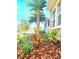 Vibrant landscaping with mulch and a mature palm tree at 4612 Terry Town Dr, Kissimmee, FL 34746