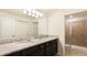 Bathroom with granite countertop, double sinks, and shower at 4651 Terrasonesta Dr, Davenport, FL 33837