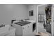 Well-lit laundry room area features modern washer and dryer units and utility sink at 4941 Casa Vista Dr, Orlando, FL 32837