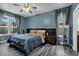 Serene main bedroom with stylish blue walls, ample natural light, and luxury vinyl plank flooring at 4941 Casa Vista Dr, Orlando, FL 32837