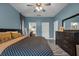 Spacious main bedroom showcasing stylish furniture, blue walls and luxury vinyl plank flooring at 4941 Casa Vista Dr, Orlando, FL 32837