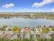 High angle shows houses lining the shore of a serene lake, with lush greenery beyond at 4981 Waterside Pointe Cir, Orlando, FL 32829